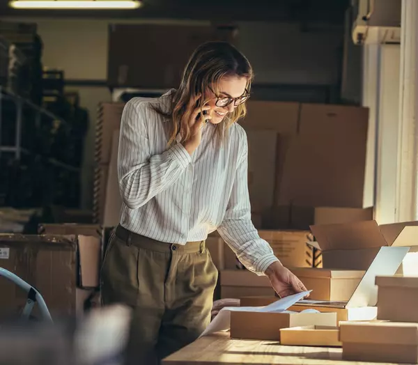 Woman in warehouse on phone
