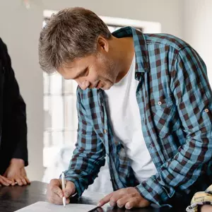 Man signing paper