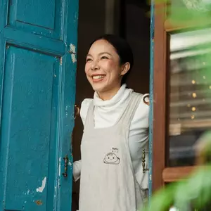 Woman holding doors open